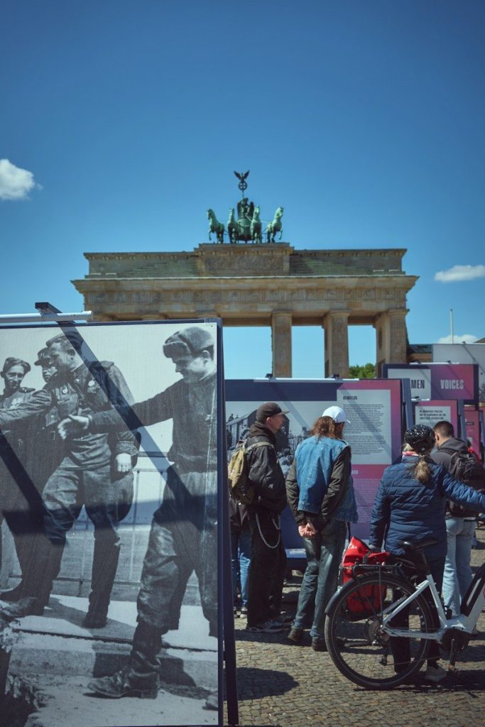 People viewing historical exhibition near brandenburg gate