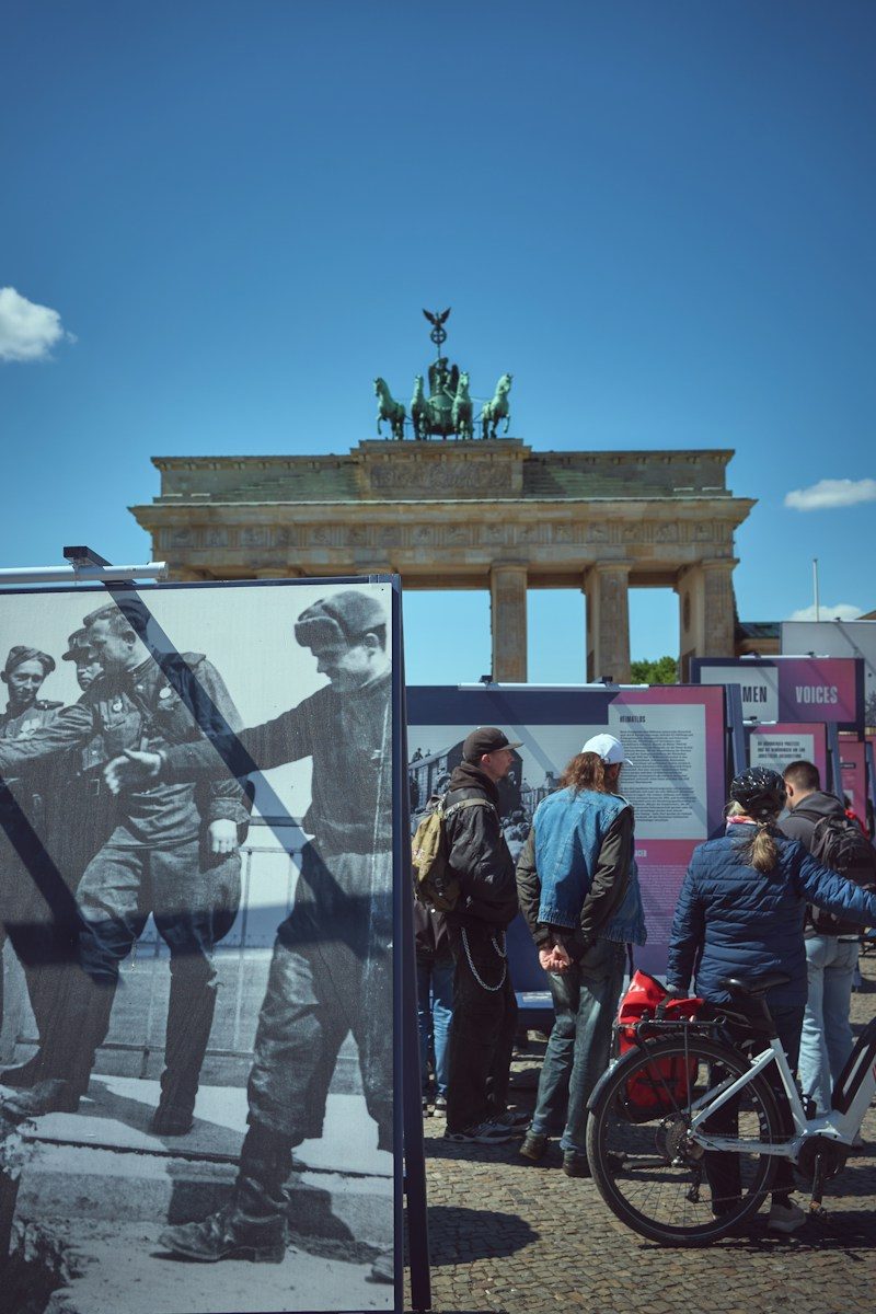 People viewing historical exhibition near brandenburg gate