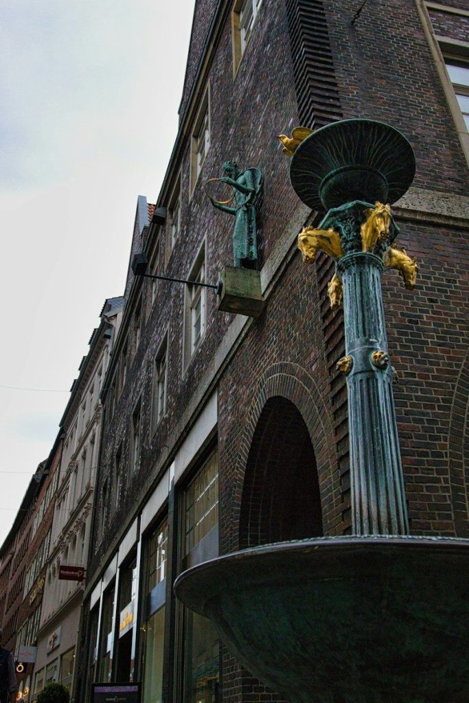 Ornate fountain on a brick building corner