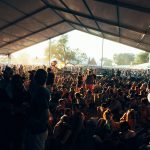 a large group of people sitting under a tent