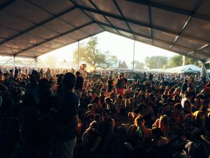 a large group of people sitting under a tent