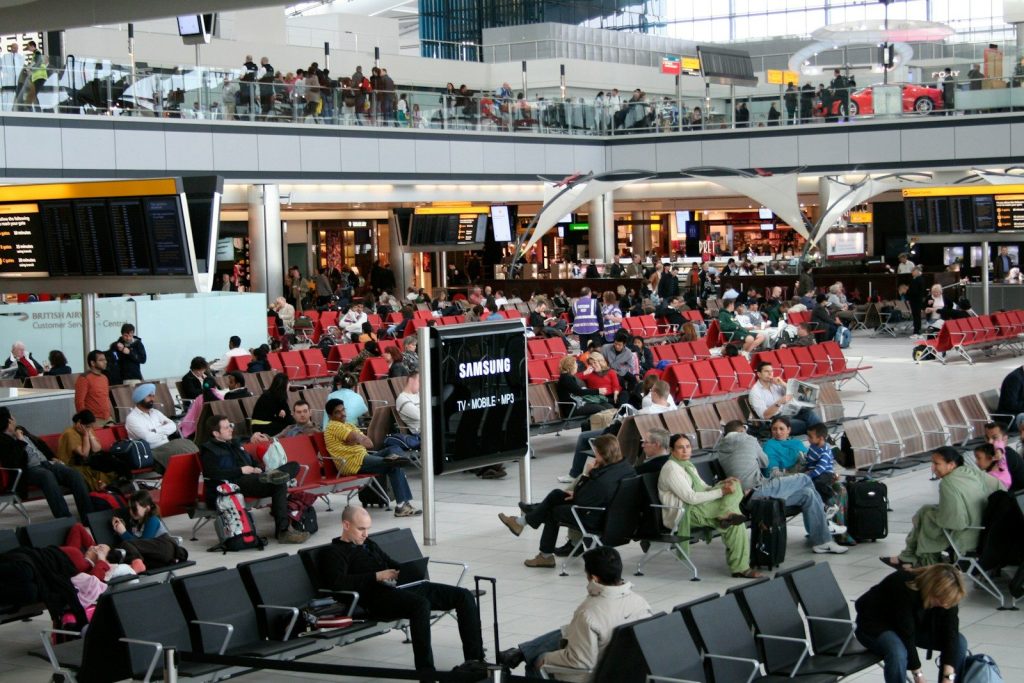 A large group of people sitting in an airport