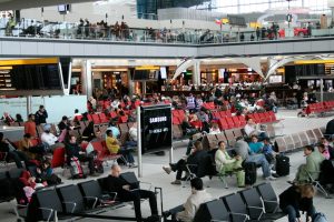 A large group of people sitting in an airport