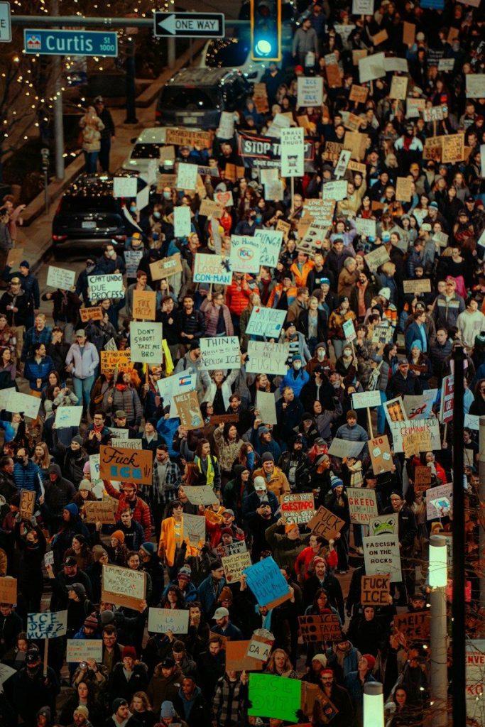 Crowd of people holding signs at a protest