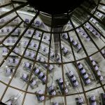 a room with a glass ceiling filled with purple cubes
